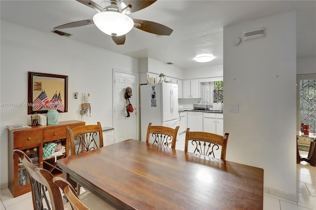 tiled dining room featuring ceiling fan