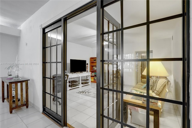 doorway with light tile patterned flooring and french doors