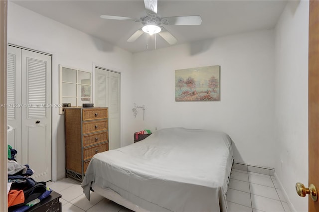 bedroom with ceiling fan and light tile patterned floors