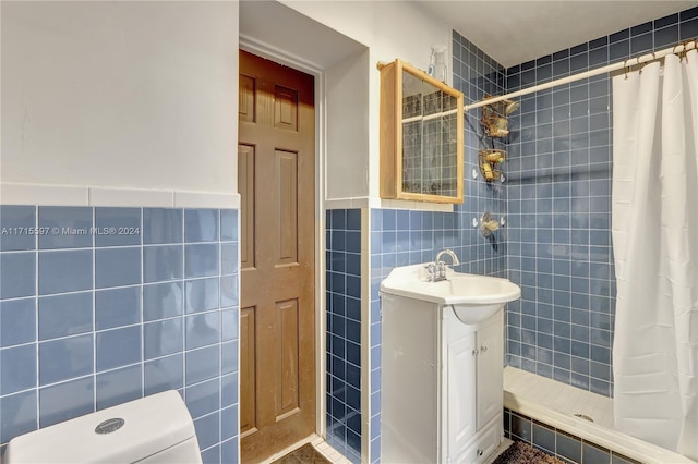 bathroom featuring vanity, toilet, tile walls, and curtained shower