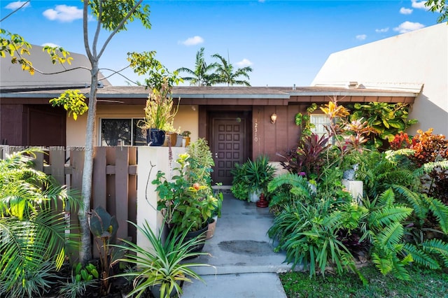 entrance to property with stucco siding