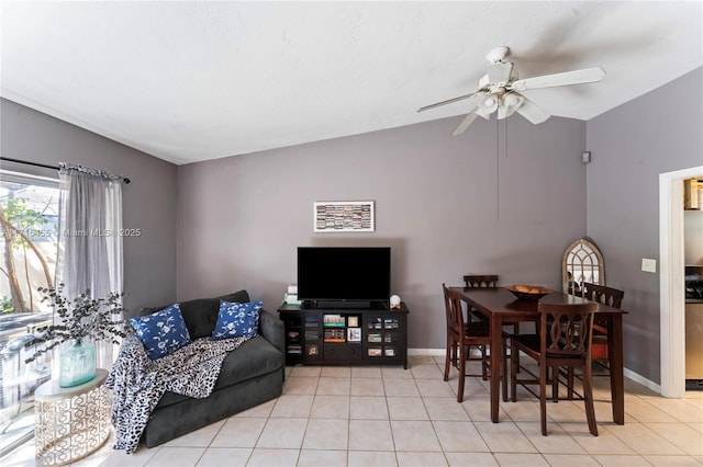 living area featuring lofted ceiling, baseboards, and tile patterned floors