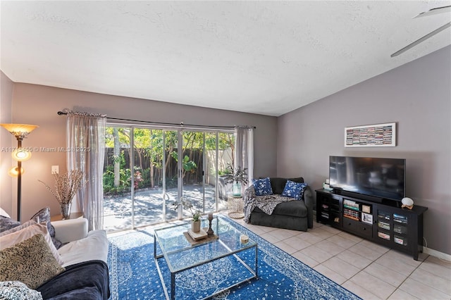 living room featuring lofted ceiling, a textured ceiling, and light tile patterned flooring