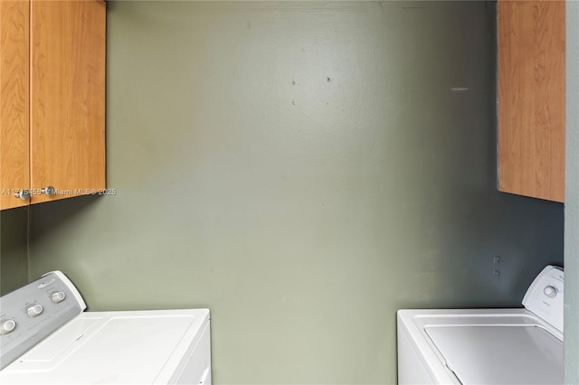 laundry area with washing machine and dryer and cabinet space