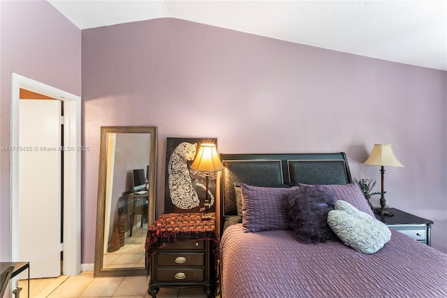 bedroom featuring lofted ceiling and tile patterned floors