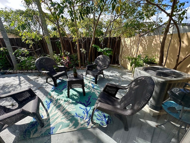 view of patio / terrace featuring a fenced backyard and central AC