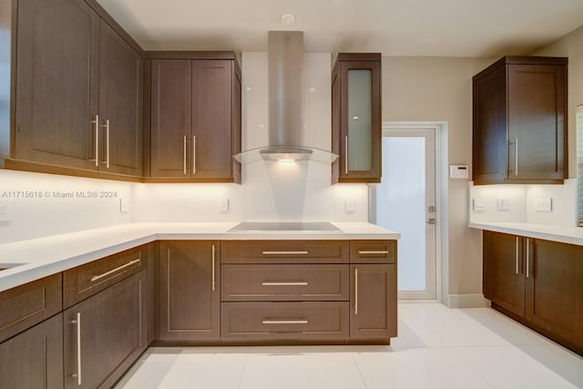 kitchen featuring black electric stovetop, wall chimney exhaust hood, and light tile patterned floors