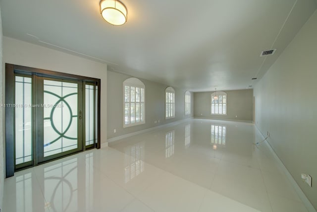 entrance foyer with plenty of natural light and light tile patterned floors