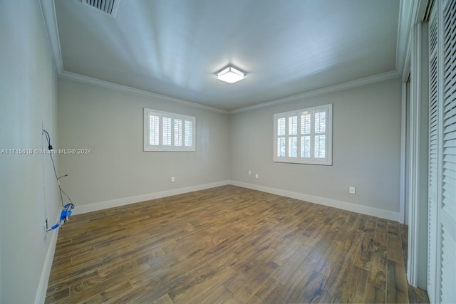 unfurnished bedroom with multiple windows, dark hardwood / wood-style floors, and ornamental molding