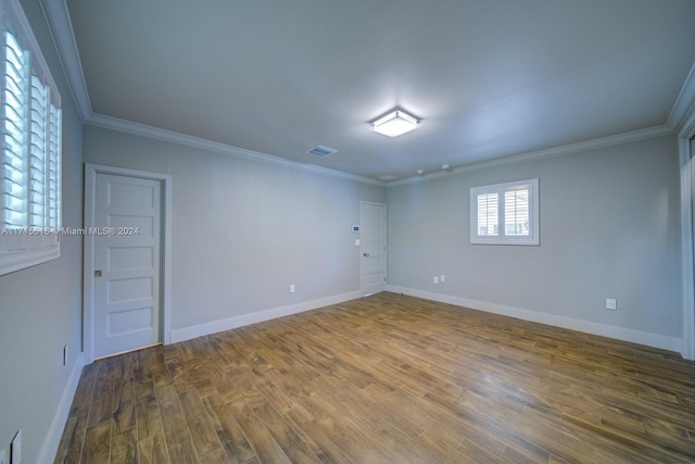 spare room with wood-type flooring and ornamental molding