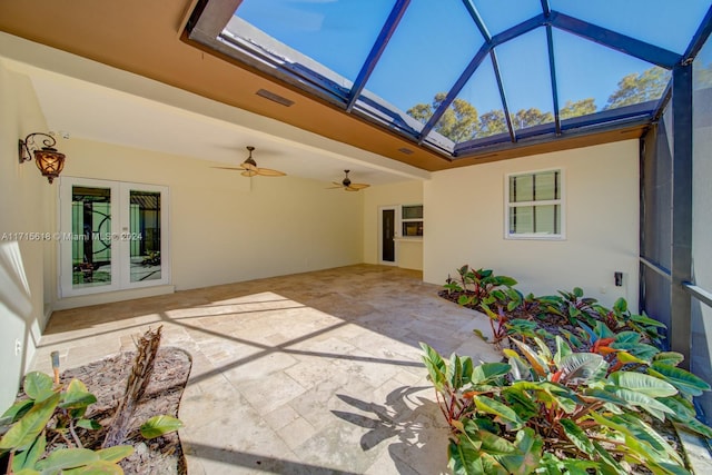 view of patio featuring a lanai and french doors