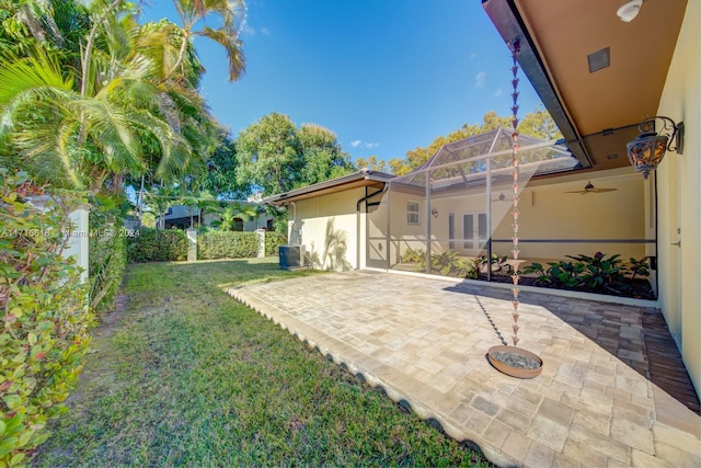 view of yard featuring central AC unit, a lanai, and a patio