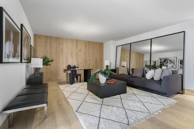 living room featuring wooden walls and wood finished floors