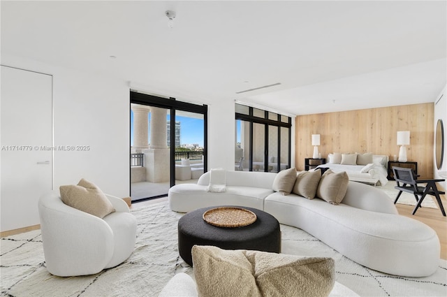 living room with wood finished floors and wooden walls