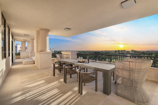 balcony at dusk with outdoor dining area