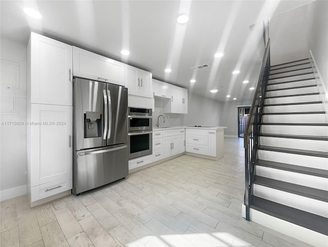 kitchen featuring white cabinets, sink, and stainless steel appliances