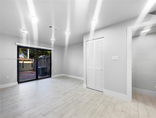 unfurnished room with light hardwood / wood-style floors