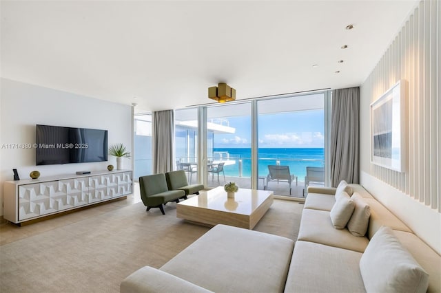 living room with a water view and a wall of windows