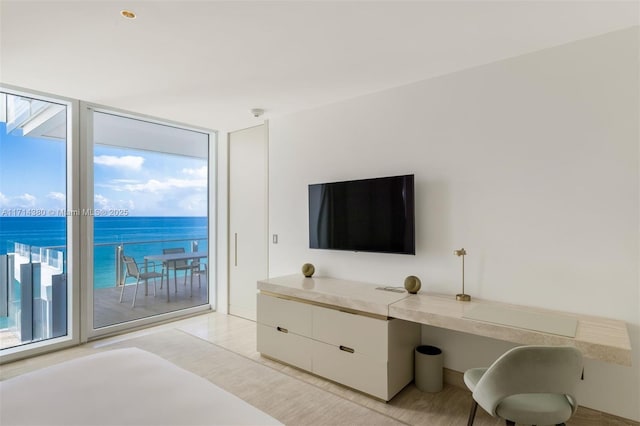 bedroom featuring access to exterior, multiple windows, and floor to ceiling windows