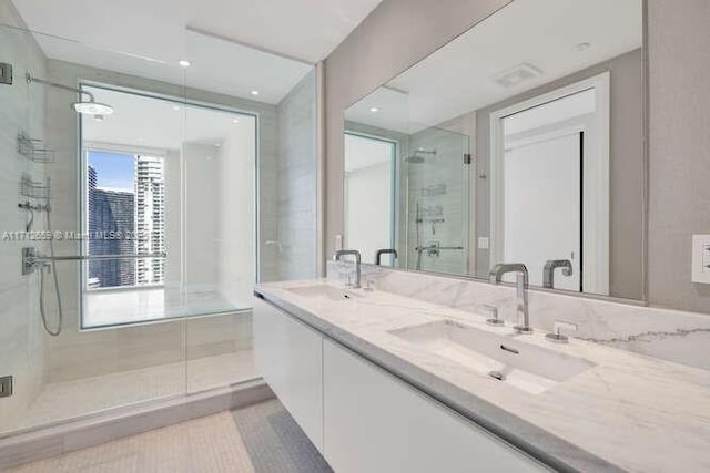 bathroom with vanity and a shower with door