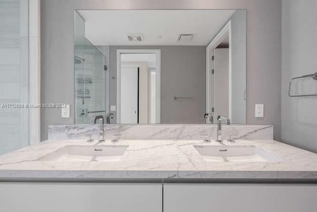 bathroom with vanity and an enclosed shower