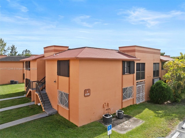 view of side of home with a yard