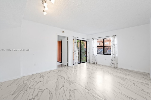 empty room featuring a textured ceiling