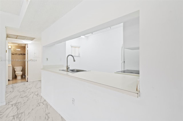 kitchen featuring white fridge and sink