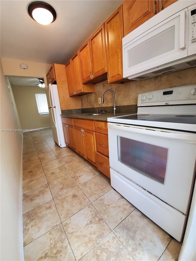 kitchen with ceiling fan, light tile patterned flooring, white appliances, and sink