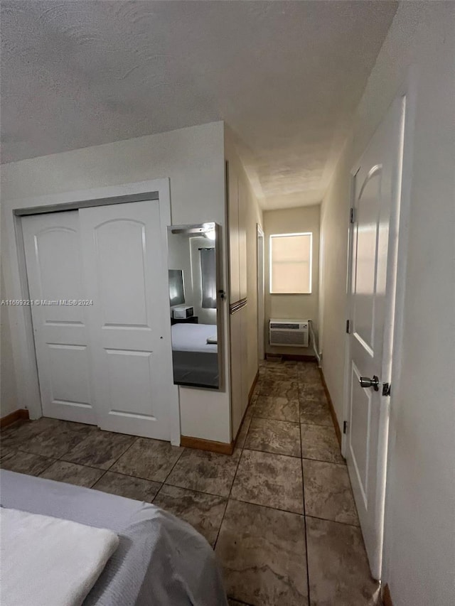 tiled bedroom with a wall mounted AC and a closet