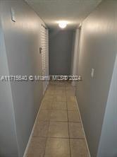 hall featuring tile patterned flooring