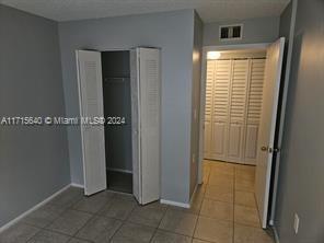 unfurnished bedroom featuring tile patterned floors and a closet