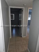 corridor with tile patterned flooring