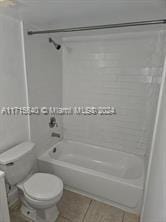 full bathroom with tile patterned floors, toilet, vanity, and tub / shower combination