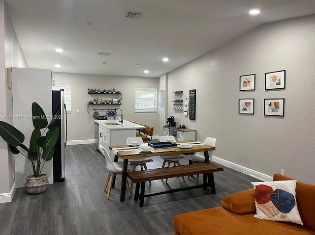 dining space featuring dark hardwood / wood-style flooring and sink