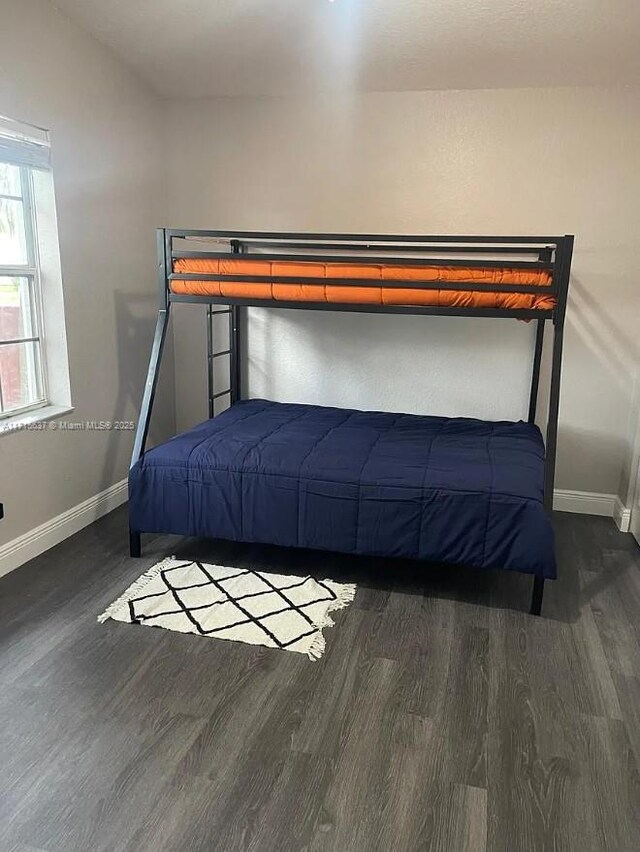 unfurnished bedroom with dark hardwood / wood-style floors