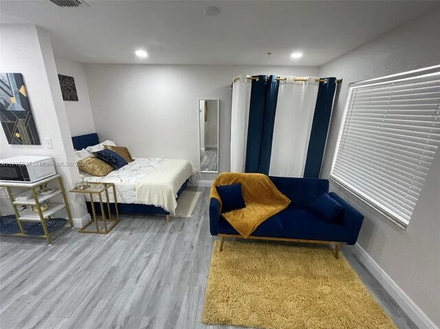 bedroom with hardwood / wood-style floors