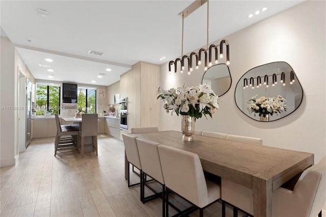 dining area featuring light wood-type flooring