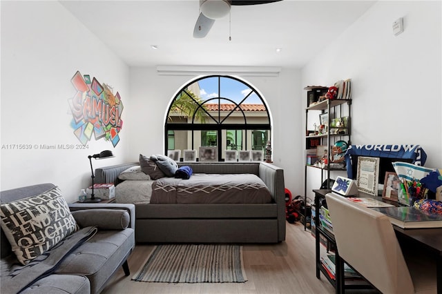 bedroom with ceiling fan and light hardwood / wood-style floors