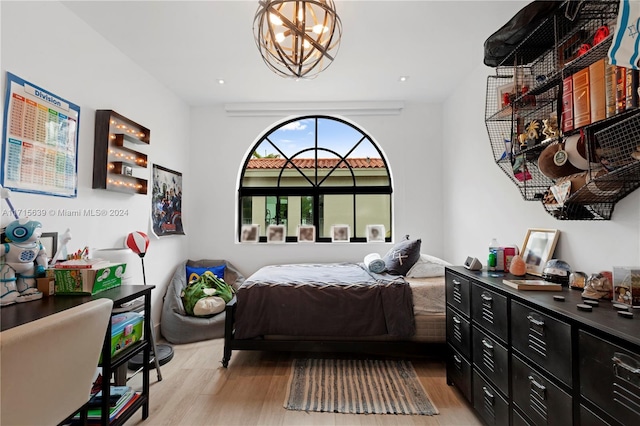 bedroom featuring light hardwood / wood-style flooring and a notable chandelier