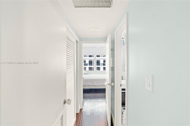 hallway with dark hardwood / wood-style flooring