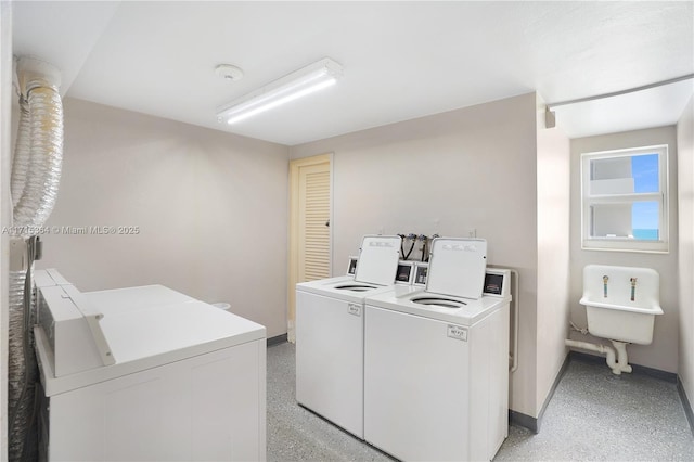 clothes washing area featuring separate washer and dryer