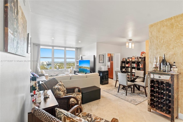 tiled living room featuring expansive windows