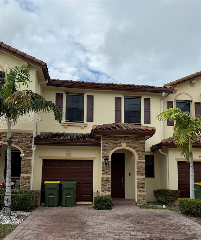 mediterranean / spanish house with a garage