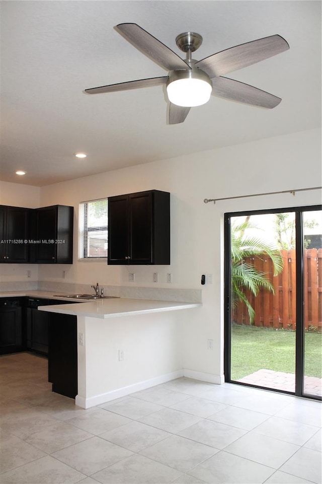 kitchen featuring a wealth of natural light, sink, ceiling fan, and light tile patterned floors