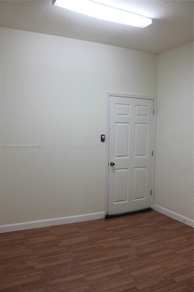 spare room with dark hardwood / wood-style flooring