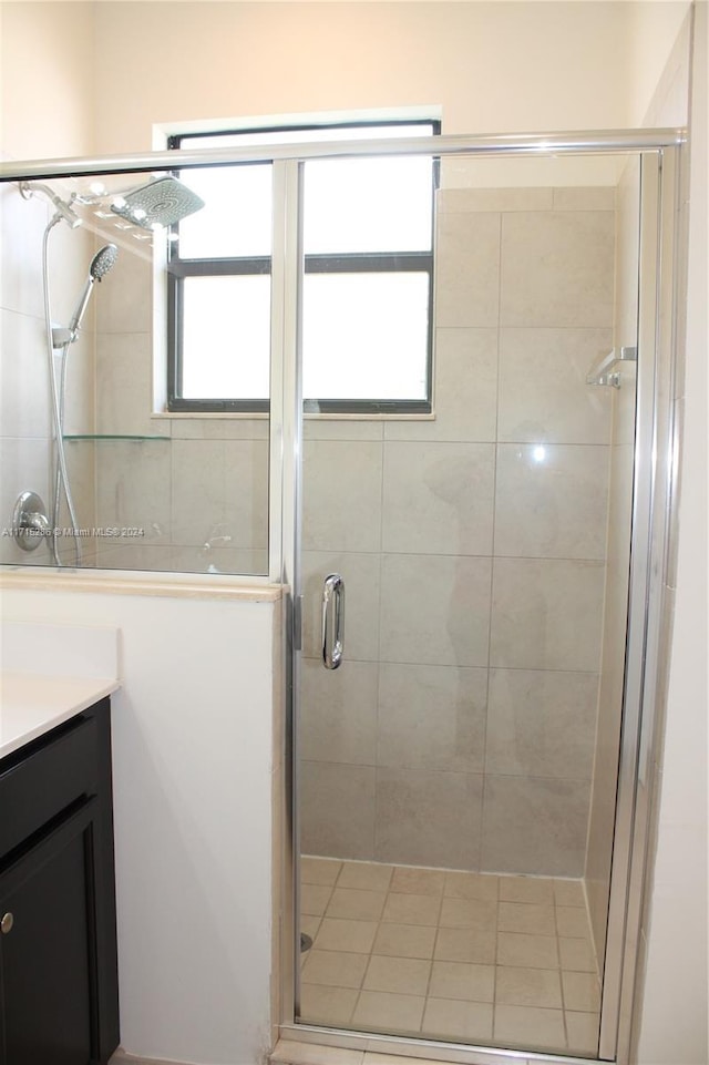 bathroom with vanity and a shower with shower door