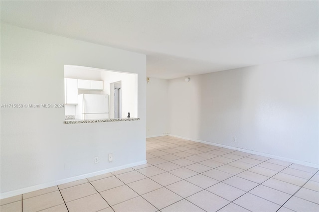 unfurnished room featuring light tile patterned flooring