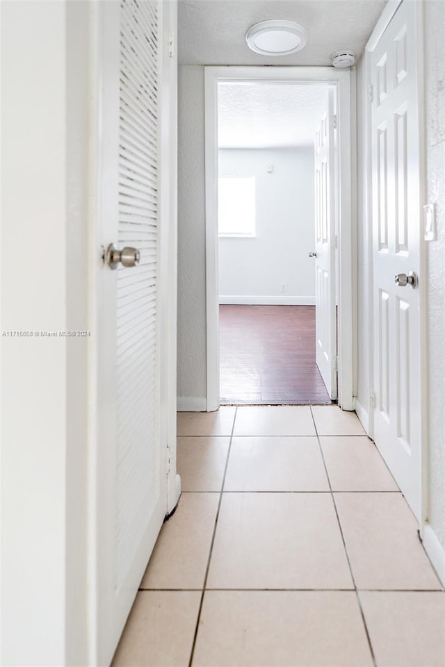 hallway featuring light tile patterned floors