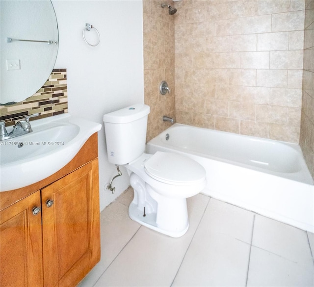 full bathroom with backsplash, tile patterned floors, toilet, vanity, and tiled shower / bath